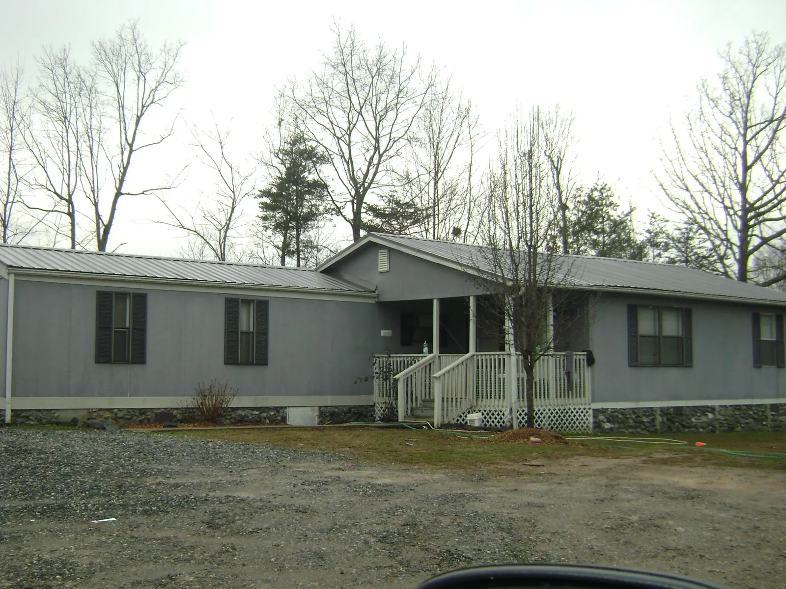 Metal roof over a manufactured home with a covered front porch in Harrington Park