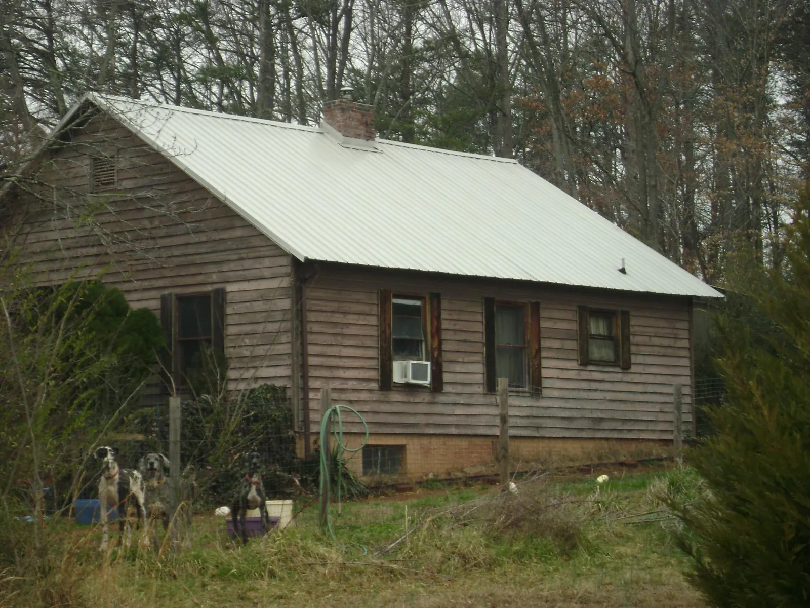 White metal roof on an old wood sided farmhouse, from a Metal Roof Installation job in Harrington Park